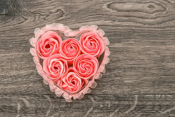 Rose petals soap over rustic wooden background — Stock Photo, Image