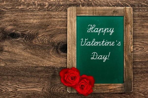 Vintage green blackboard with red roses — Stockfoto