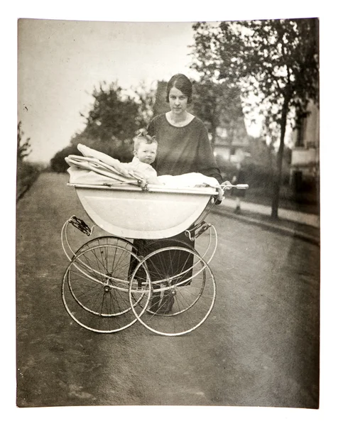 Mother with baby in vintage buggy — Stock Photo, Image