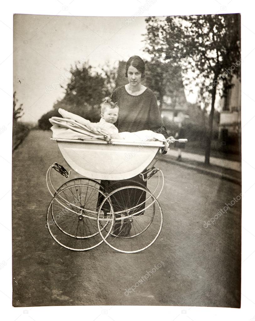 mother with baby in vintage buggy
