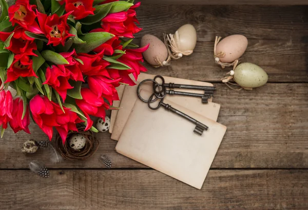 Vintage easter decoration with eggs and red tulips — Stock Photo, Image