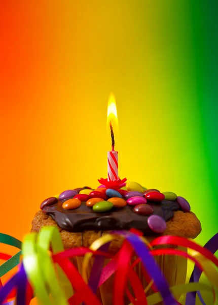 birthday cupcake with festive decoration and candle