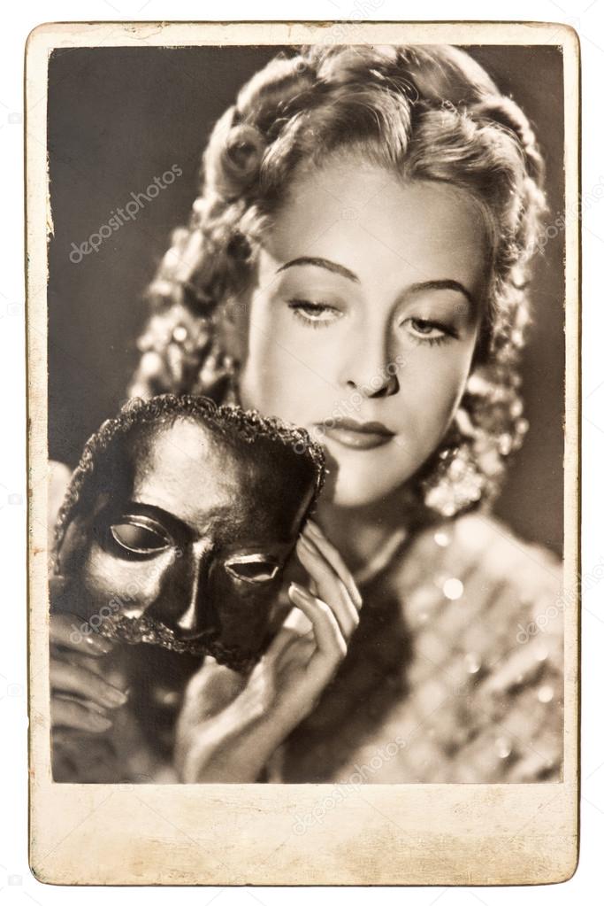 Portrait of young woman with a carnival mask