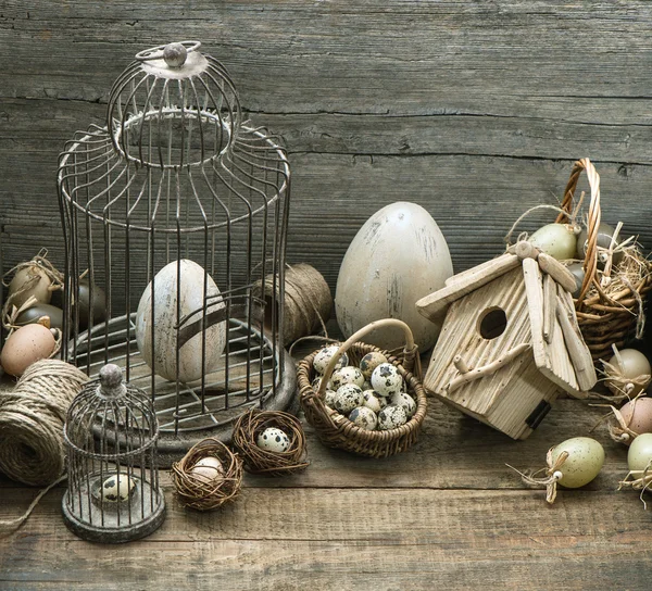 Vintage påsk dekoration med ägg, fågelholk och fågelbur Stockbild
