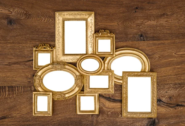 Antique golden framework over rustic wooden wall — Stock Photo, Image
