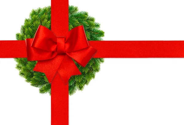 Red ribbon bow and green christmas wreath — Stock Photo, Image