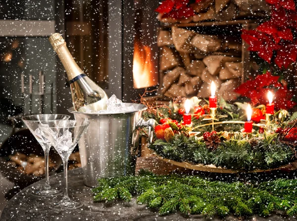 Bottle of champagne, glasses and fireplace — Stock Photo, Image