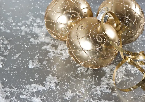 Golden christmas balls with snow decoration — Stock Photo, Image