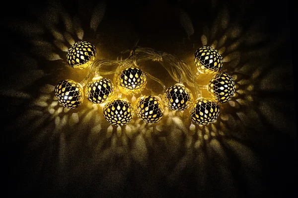 Glowing golden lights on dark background — Stock Photo, Image