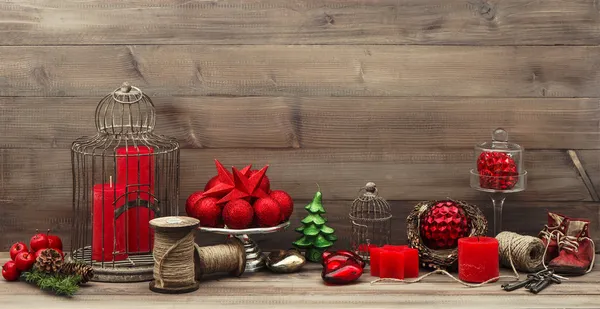 Retro style christmas decorations with red candles — Stock Photo, Image