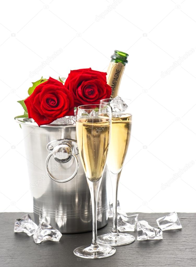 bottle of champagne, two glasses and red roses