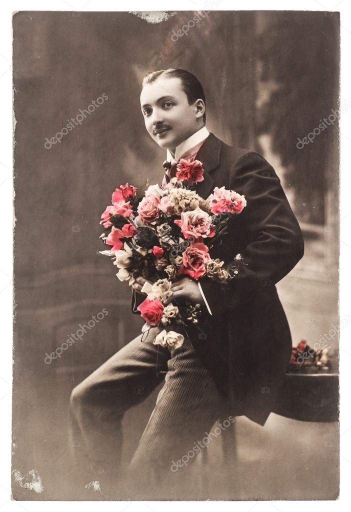 Young man with rose flowers. vintage photo