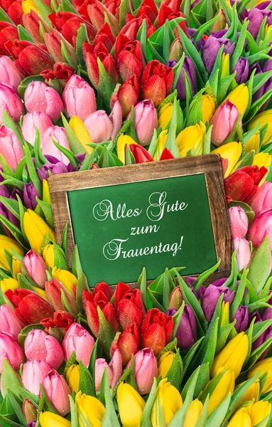 Tulips and blackboard. fresh spring flowers — Stock Photo, Image