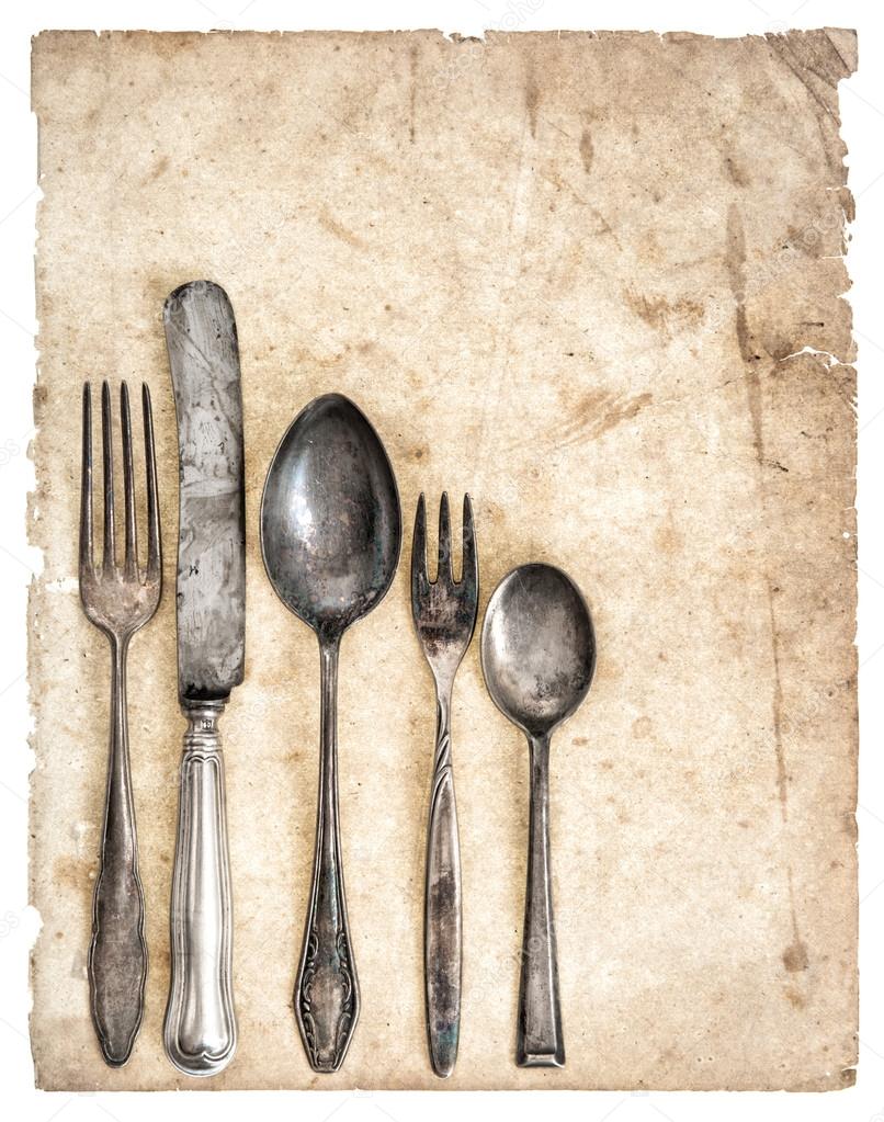 Antique cutlery and old cook book page