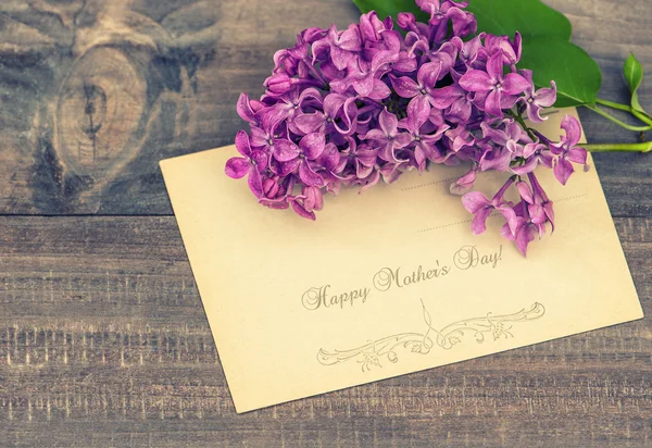 Lilac flowers on wooden background — Stock Photo, Image