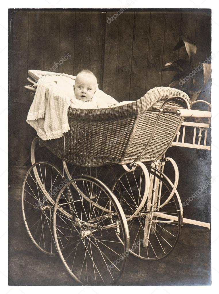 Cute baby in vintage buggy. nostalgic vintage picture