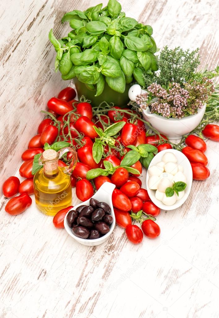 fresh basil, tomatoes, mozzarella and olive oil. food background