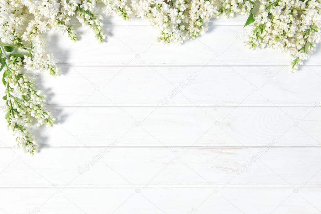 Bright washed wooden background with white lilac flowers decoration