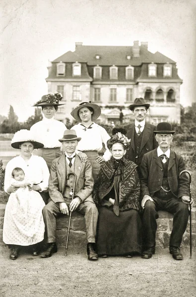 Old family photo with house. Antique picture with original film grain