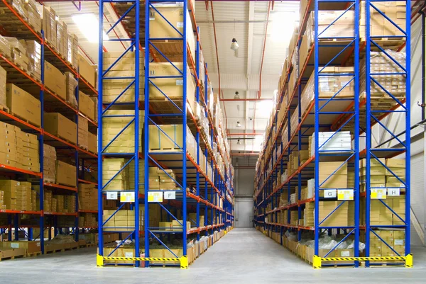 Warehouse with shelves and boxes Royalty Free Stock Images