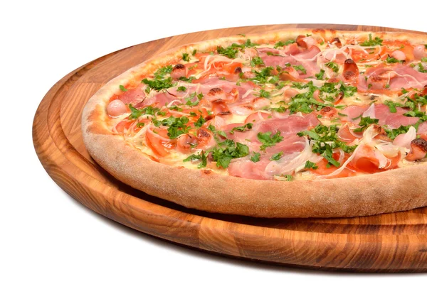 Pizza with ham tomato and onion on a wooden platter — Stock Photo, Image