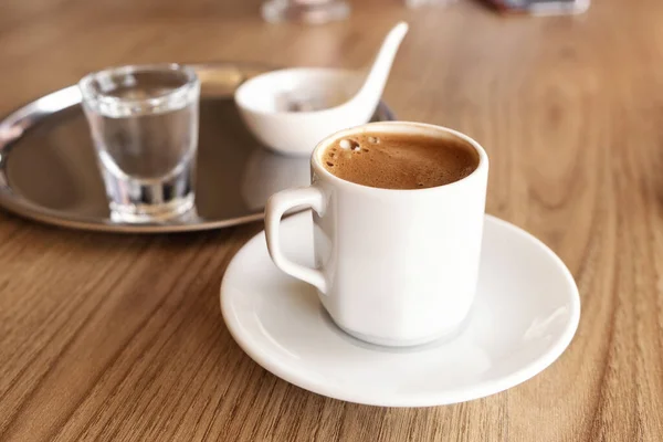 Traditional Turkish coffee with cold water and Turkish delight in cafe. Selective focus — Stock Photo, Image