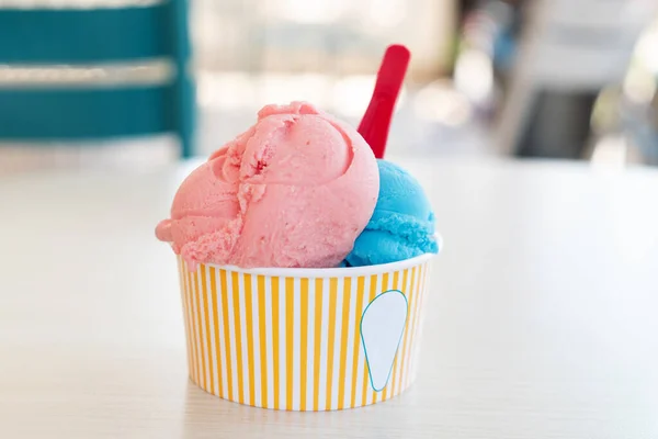 Balls if ice cream in paper cup. Refreshing snack on a hot day Vacation concept. Selective Focus. Copy space Stock Photo