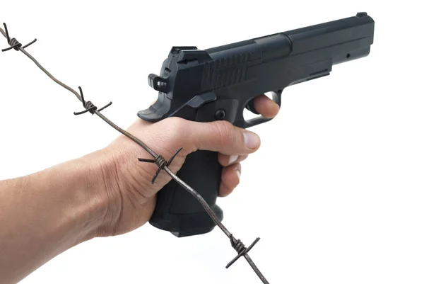 Hand with gun and barbed wire — Stock Photo, Image