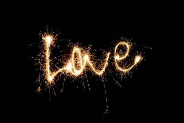 The inscription "Love" from sparklers — Stock Photo, Image