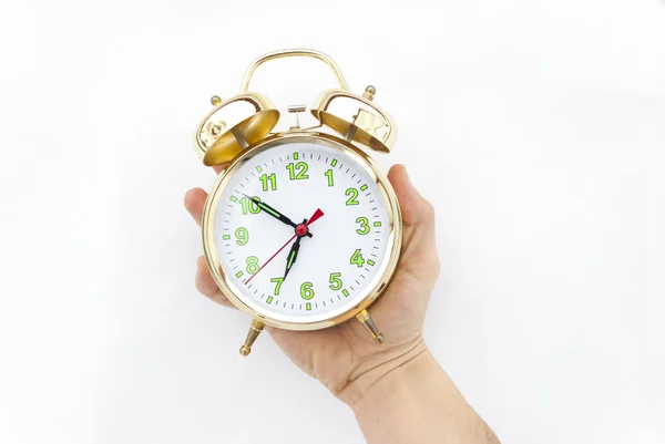 Alarm clock in a hand on a white background — Stock Photo, Image