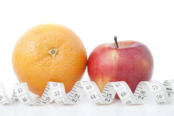 Orange and apple with a measuring tape — Stock Photo, Image