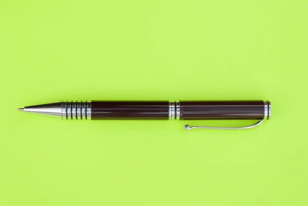 Kugelschreiber auf einem grünen Blatt Papier — Stockfoto