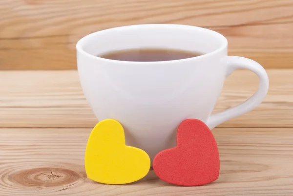Cup of coffee and two hearts — Stock Photo, Image