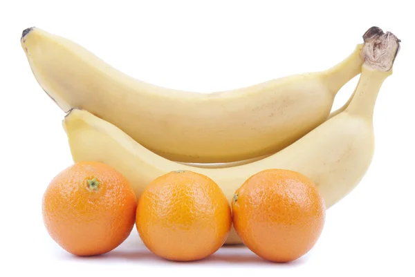 Bananas and oranges on a white background. — Stock Photo, Image