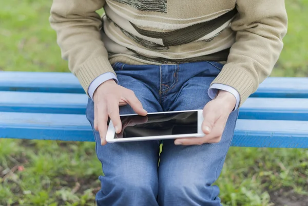 Man with tablet in park.