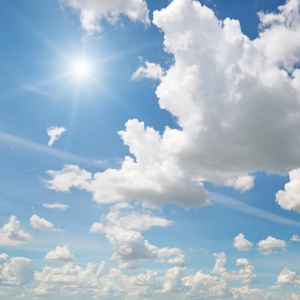 Sun on blue sky with white clouds — Stock Photo, Image