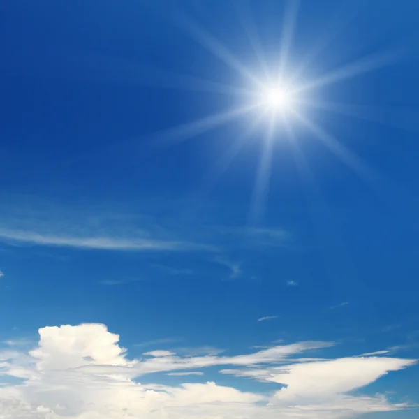 Sun on blue sky with white clouds — Stock Photo, Image