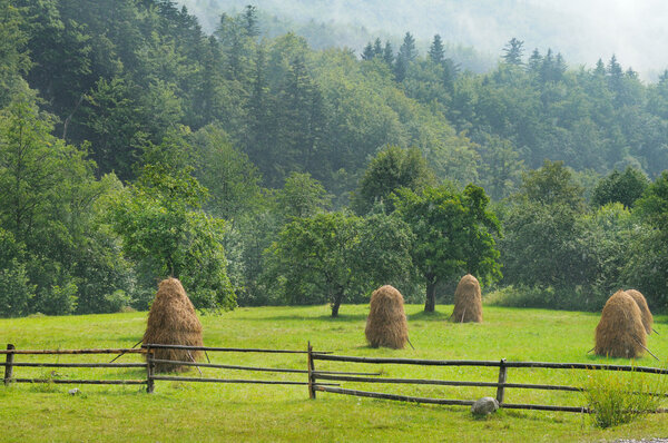 haystacks in the mountain valley