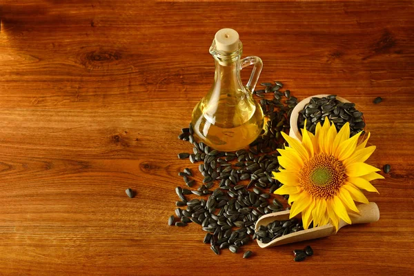 Sunflower Seeds Oil Jug Sunflower Flower Wooden Table — Stock Photo, Image