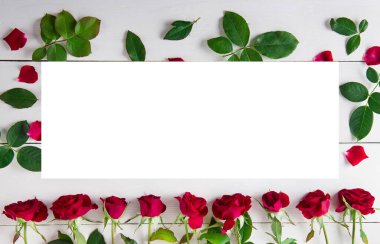 Creative frame made of red roses pattern. Free space for text.