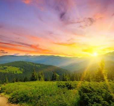 Beautiful hills glowing by sunlight at twilight. Dramatic scene. Colorful sky. Carpathian, Ukraine, Europe.