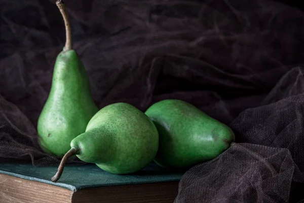 Organic Green Pears Ancient Book Front Black Background Close Still — Stock Photo, Image