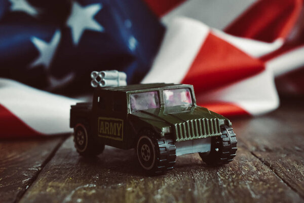 Army Car Toy with American Flag Background