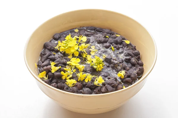 Bowl of beans with flowers — Stock Photo, Image