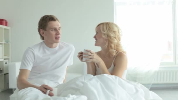 Couple drinking tea at bed — Stock Video