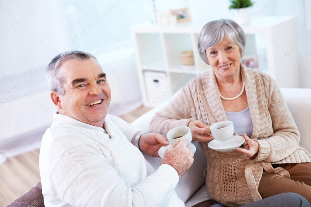 Mature man and his wife drinking tea