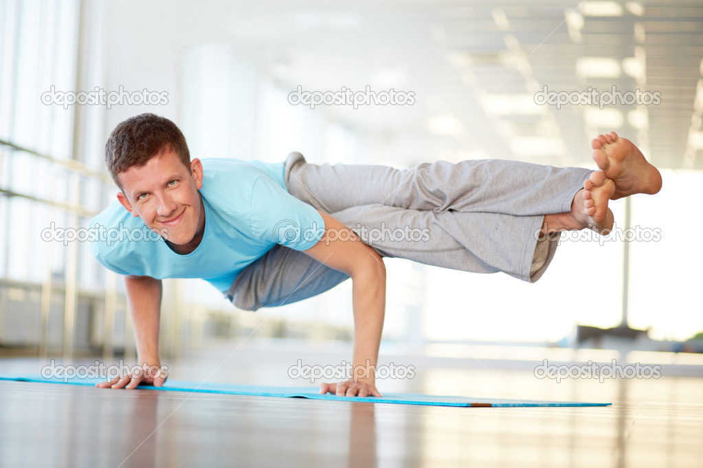 Young man exercising in gym