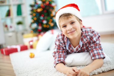 neşeli çocuk yerde yatarken Noel günü