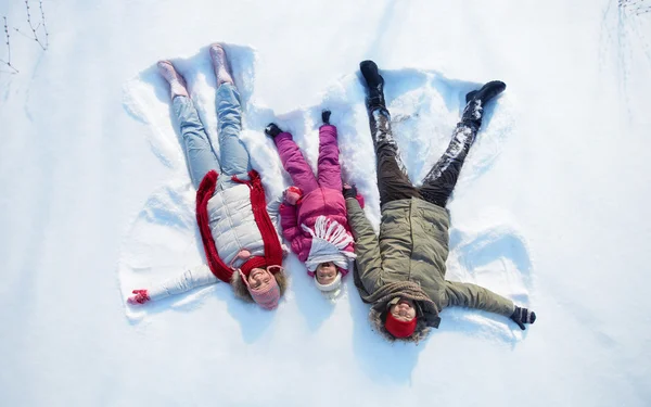 Parents and daughter having fun in snowdrift — Stock Photo, Image