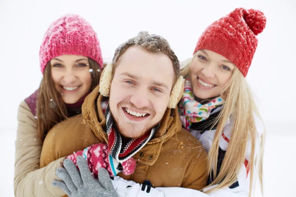 Happy girls embracing their friend — Stock Photo, Image